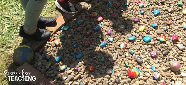 Shadows of students looking at the Kindness Rock Garden